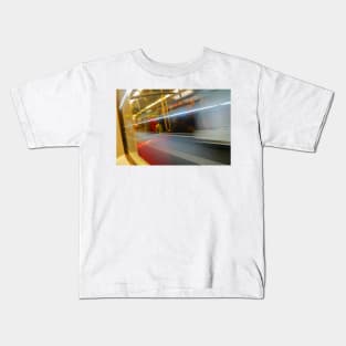 Commuters or passengers blurred in motion through window of passing train Kids T-Shirt